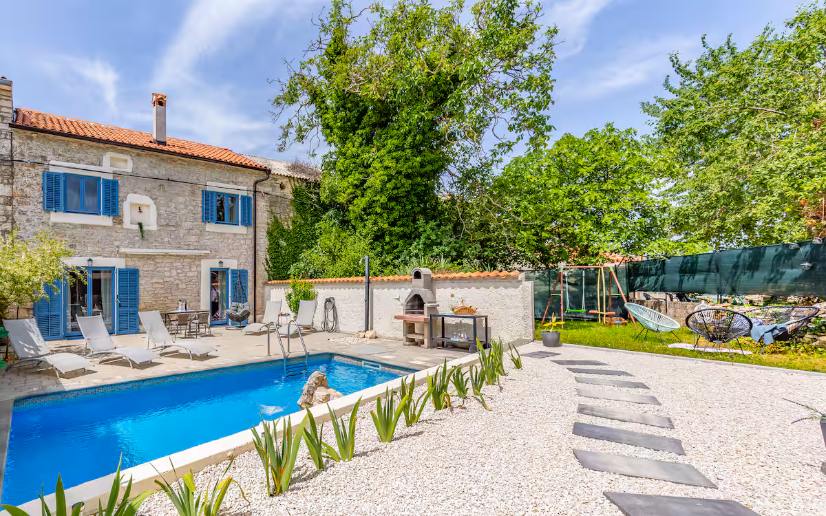 House and pool with garden by day