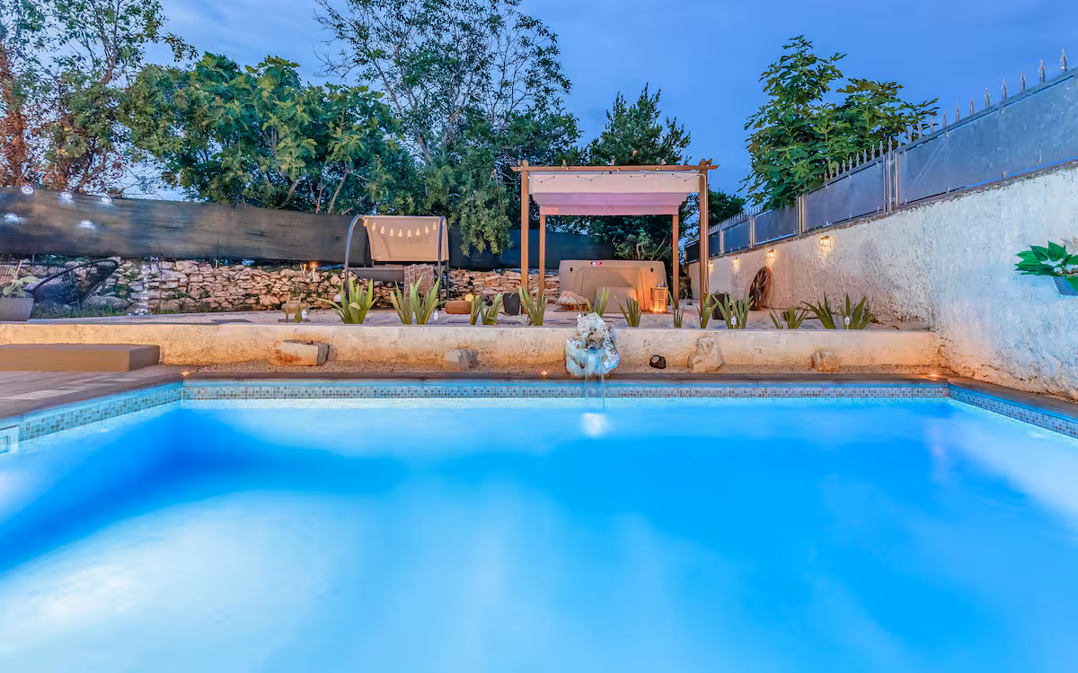 Pool at dusk with loungers